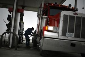 Truck driver Randy Walker fills his rig's tanks with biodiesel fuel at a gas station